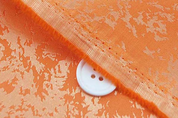 イベントや衣装に最適な光沢感のある素材　ポリエステルジャガード　炎の柄　オレンジ  